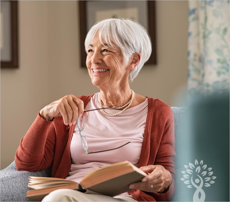 Old woman smiling with glasses in her hands